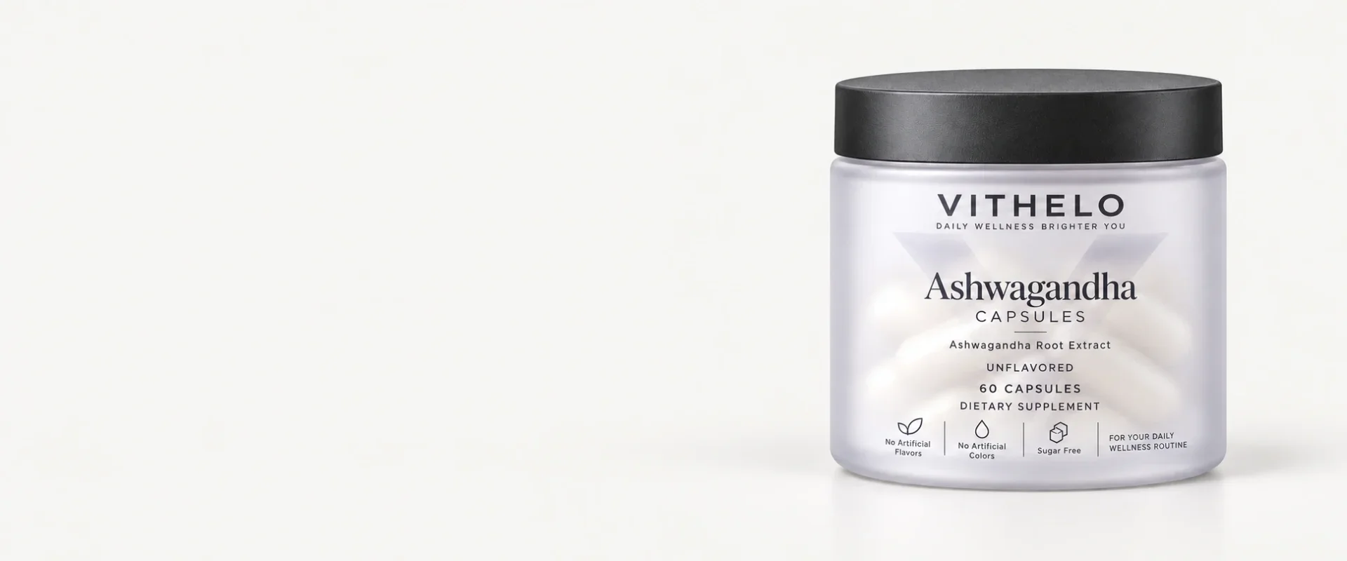 VITHELO Ashwagandha capsule bottle at the right of a wide pale-gray studio scene.